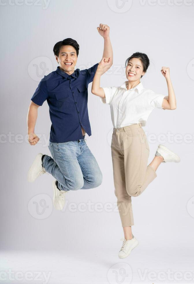 Image of an Asian couple posing on a white background photo