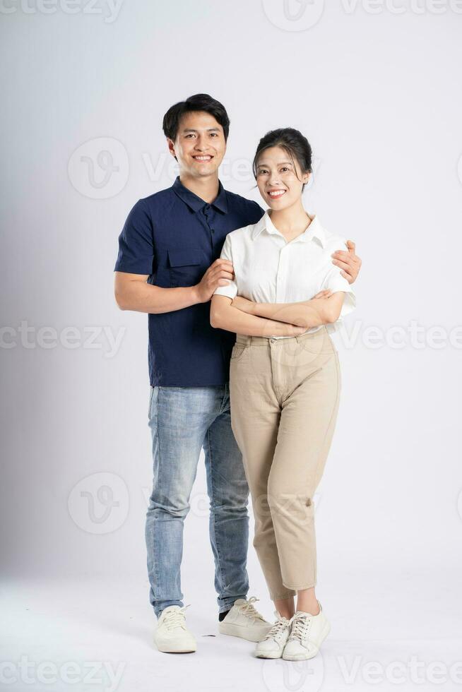 Image of an Asian couple posing on a white background photo