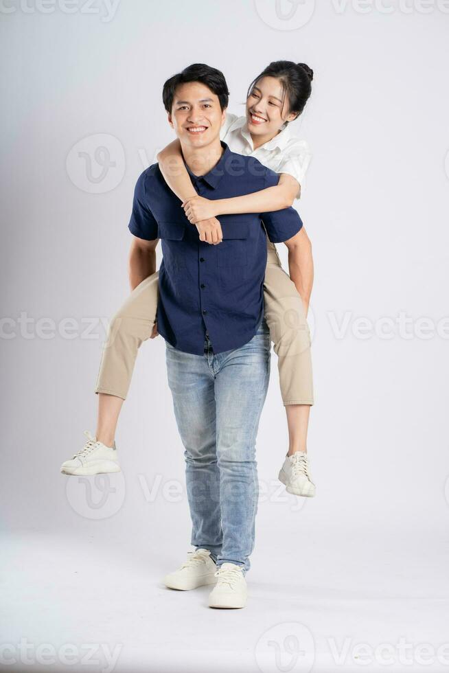 Image of an Asian couple posing on a white background photo