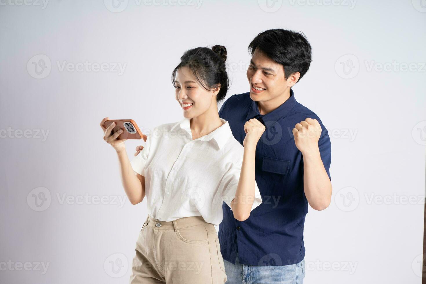 Image of an Asian couple posing on a white background photo