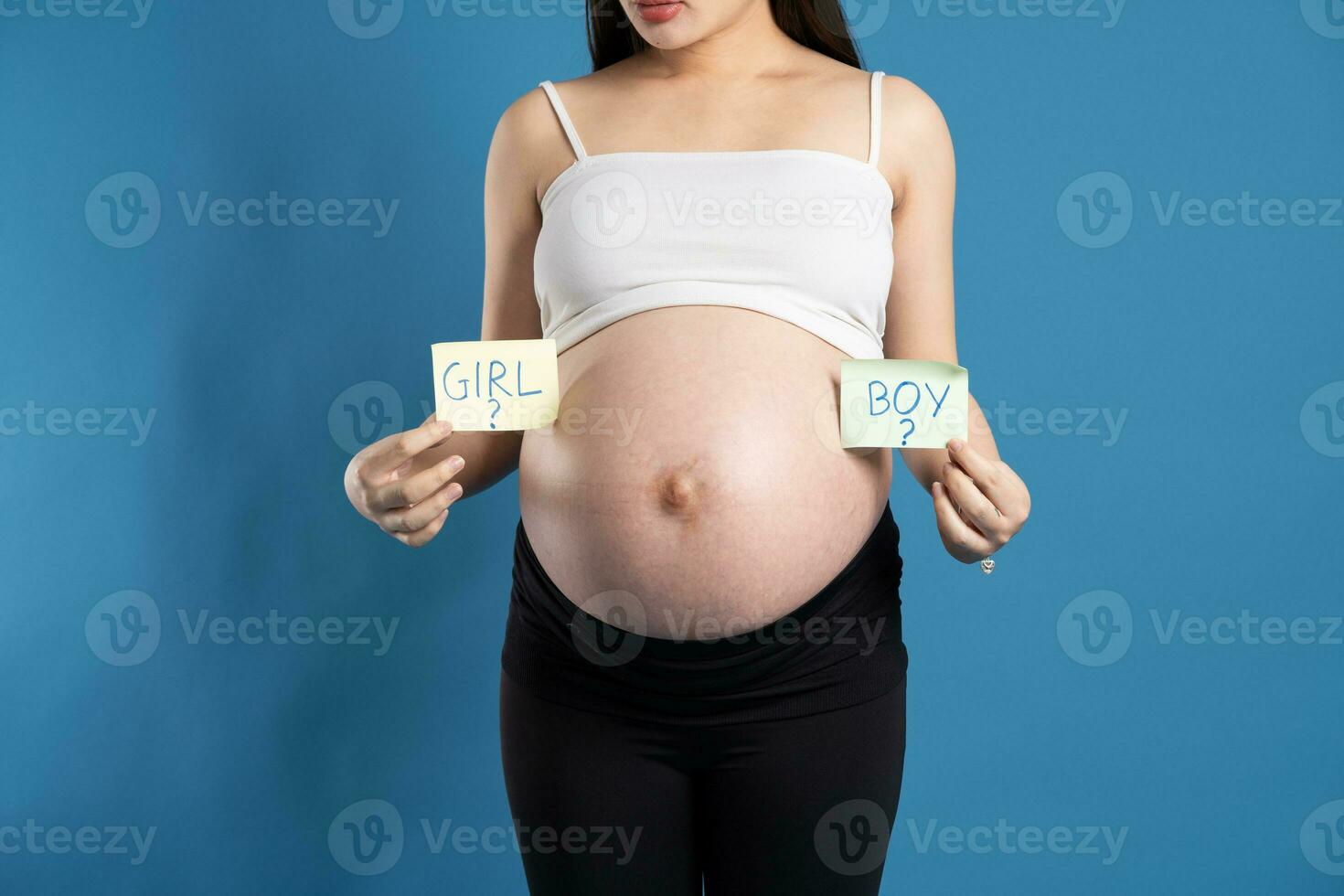 Portrait of pregnant asian woman, isolated on blue background photo