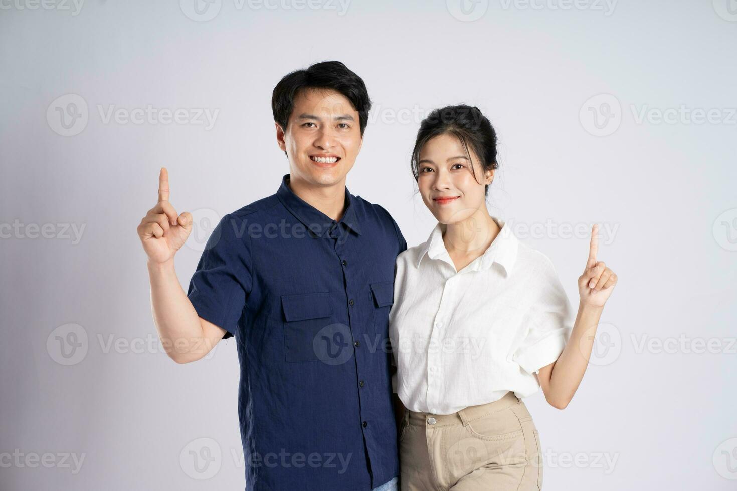 Image of an Asian couple posing on a white background photo