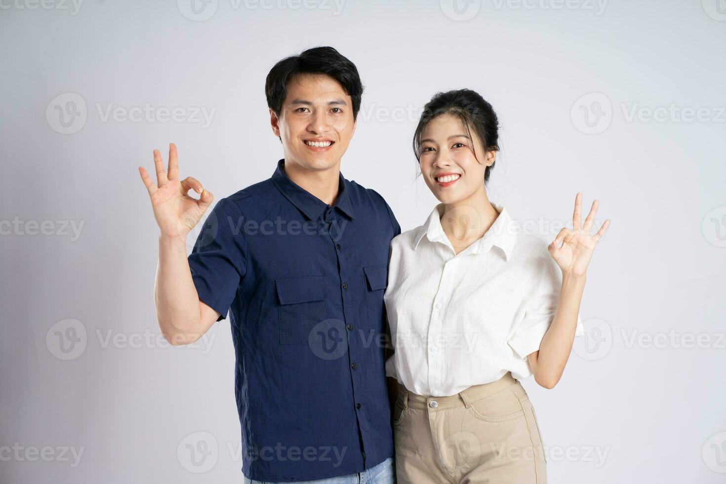 Image of an Asian couple posing on a white background photo