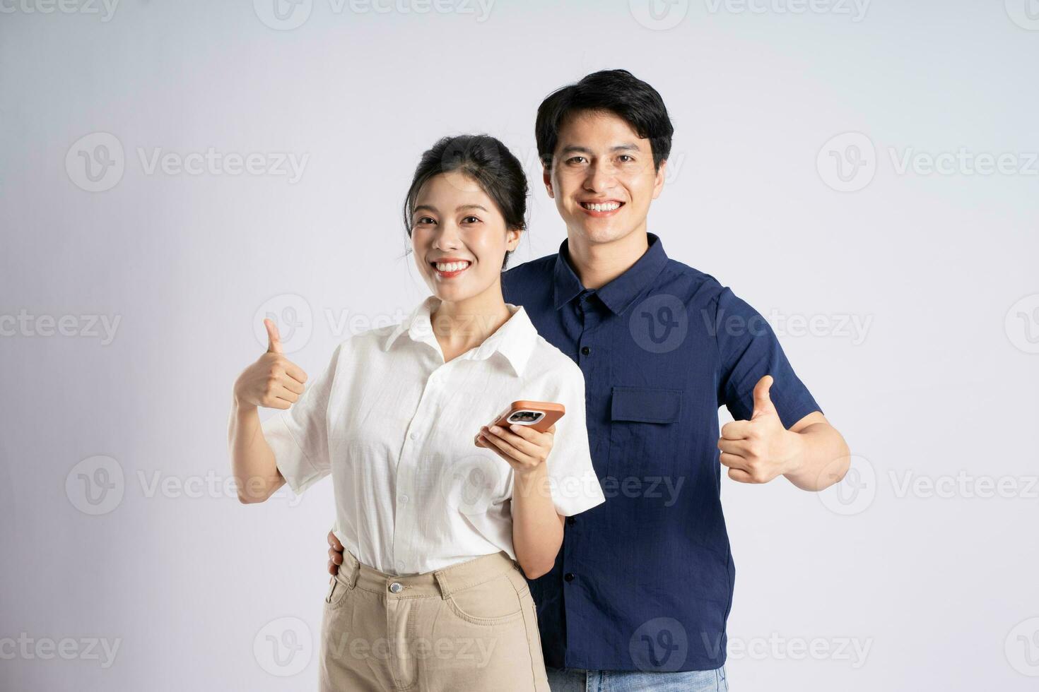 Image of an Asian couple posing on a white background photo