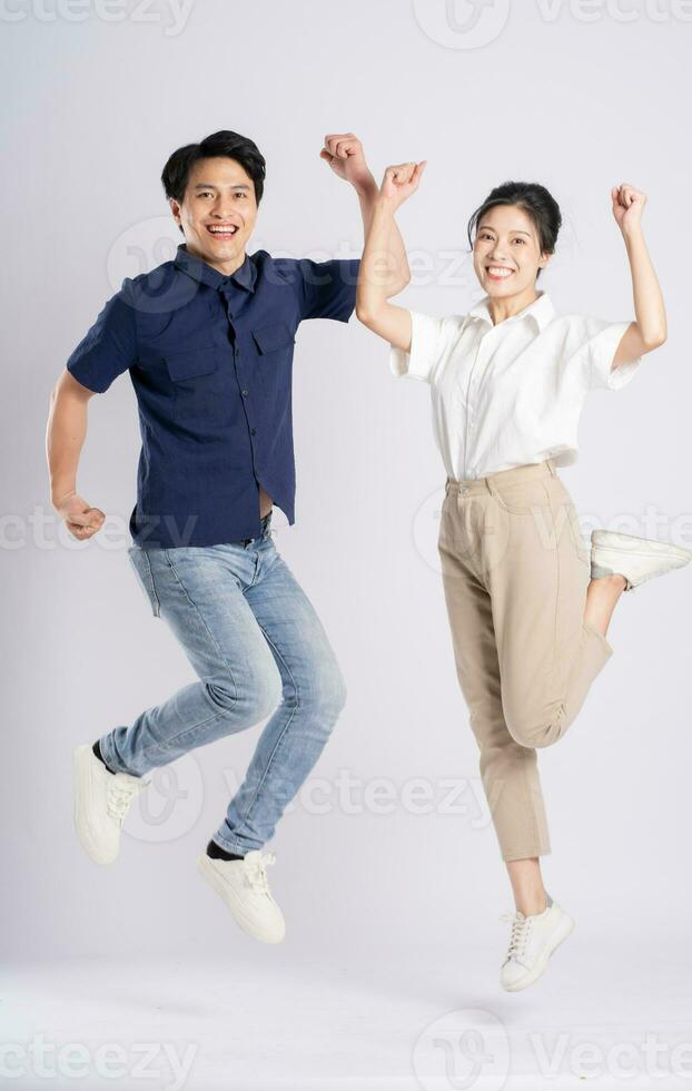 Image of an Asian couple posing on a white background photo