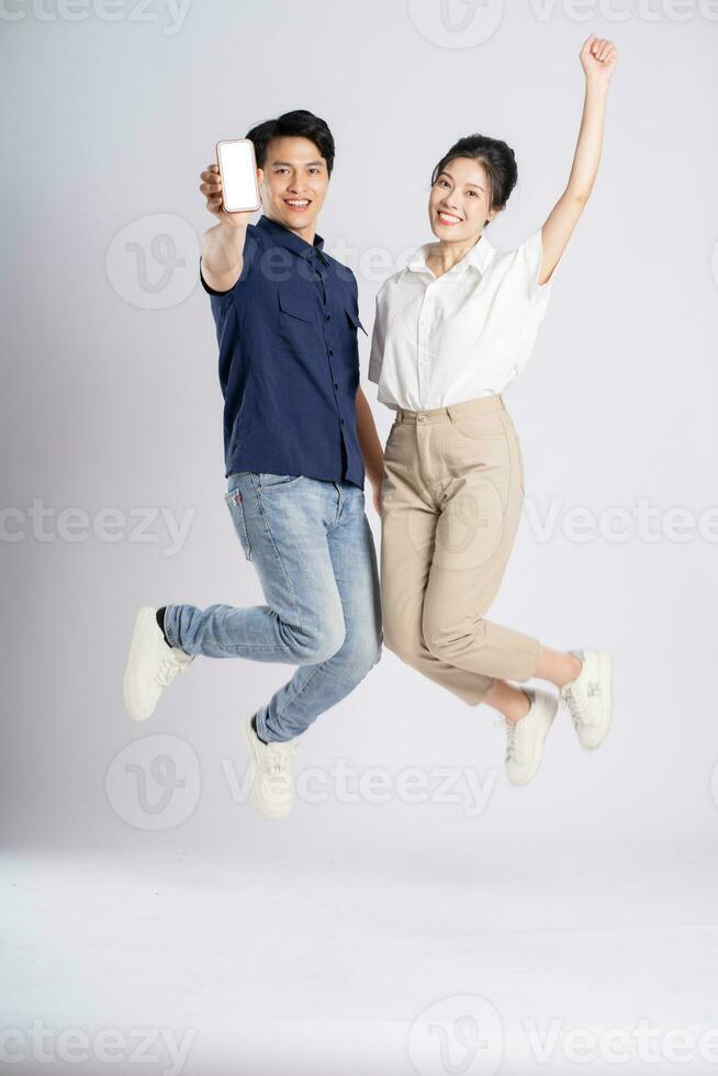 Image of an Asian couple posing on a white background photo