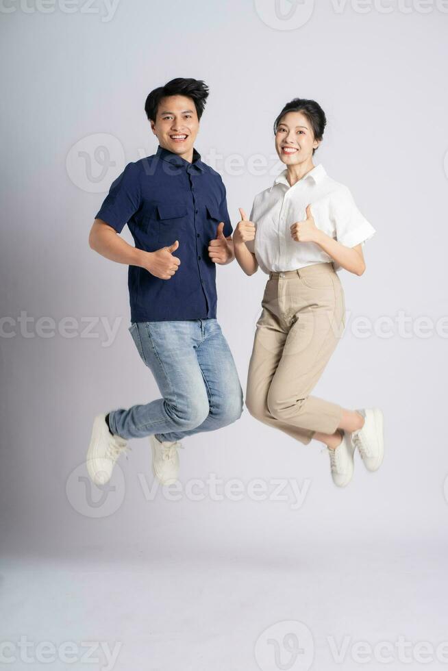 Image of an Asian couple posing on a white background photo