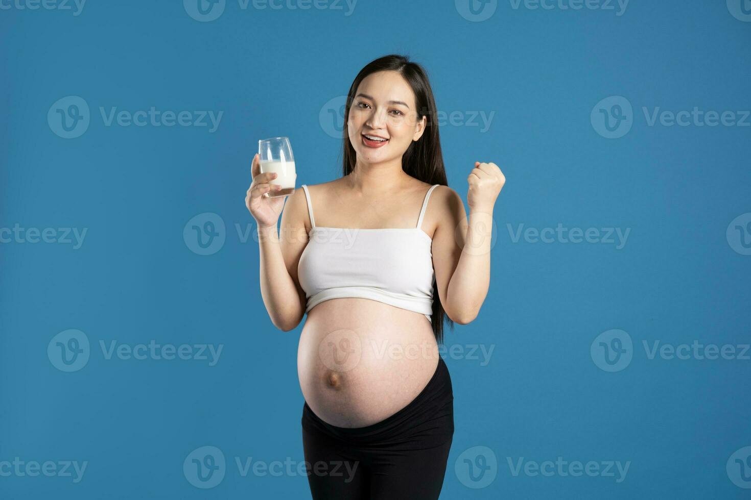 Portrait of pregnant asian woman, isolated on blue background photo