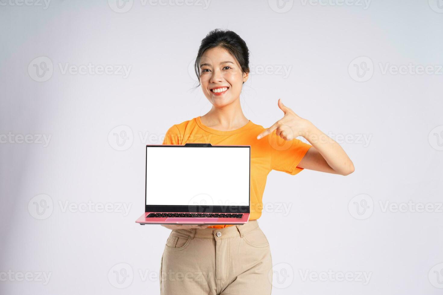 Portrait of cheerful happy Asian woman posing on white background photo