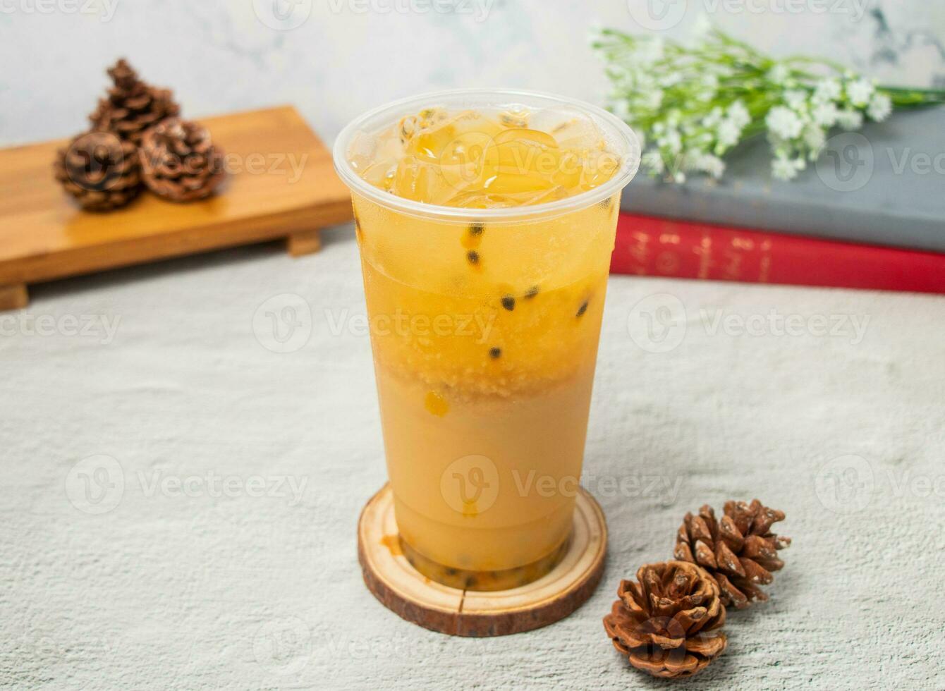 Passion fruit iced tea served in disposable glass isolated on background top view of taiwan drink photo
