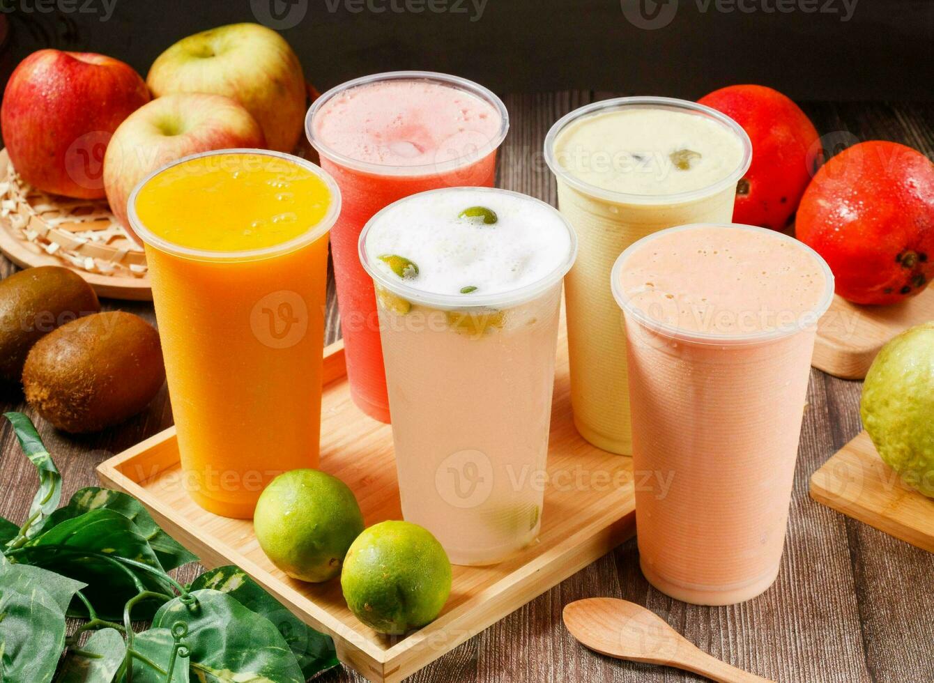 Assorted fresh juices watermelon juice, Kumquat Lemon, papaya milk, mango juice, Avocado Pudding Milk served in glass isolated on table top view of morning vitamins drink photo