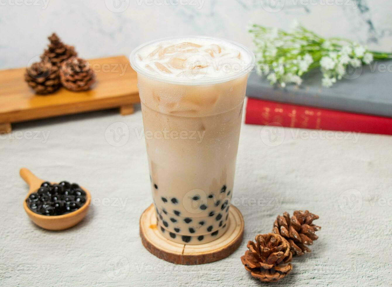 Pearl milk ice tea served in disposable glass isolated on background top view of taiwan drink photo