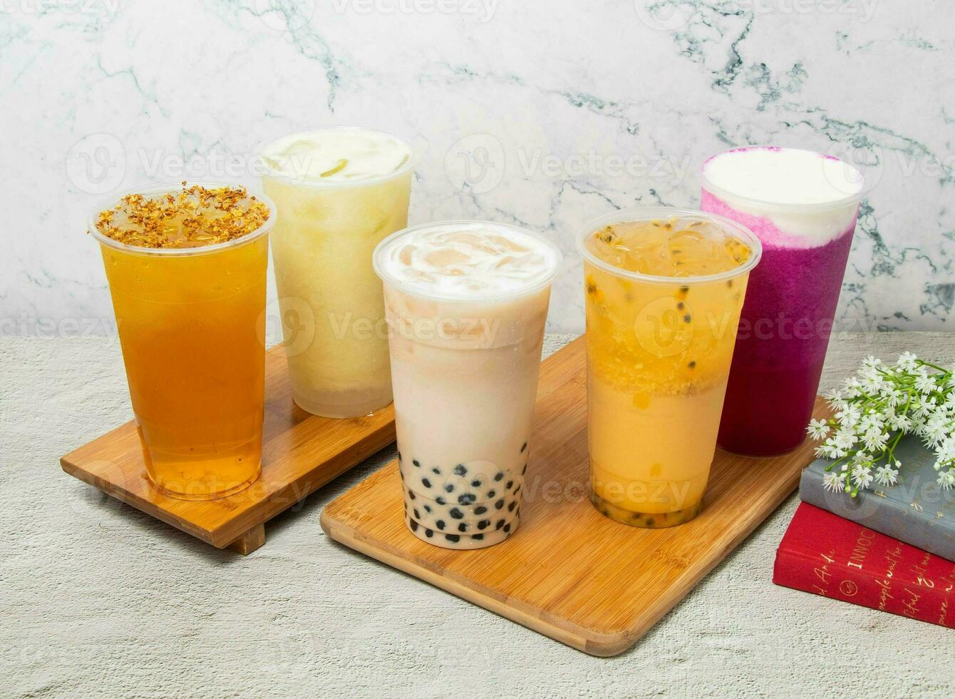 Assorted Fruit iced tea include Passion fruit, Pearl milk, Dragon Cheese Milk, Guava Lemonade iced, Osmanthus Oolong, served in disposable glass isolated on background top view of taiwan drink photo