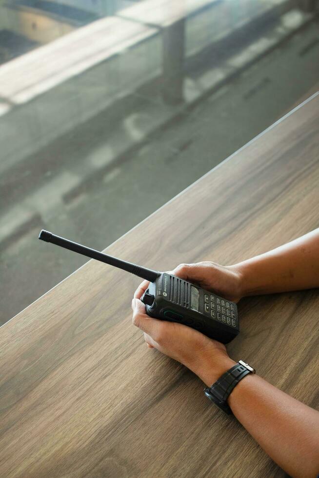 hand hold radio communication with working table background photo