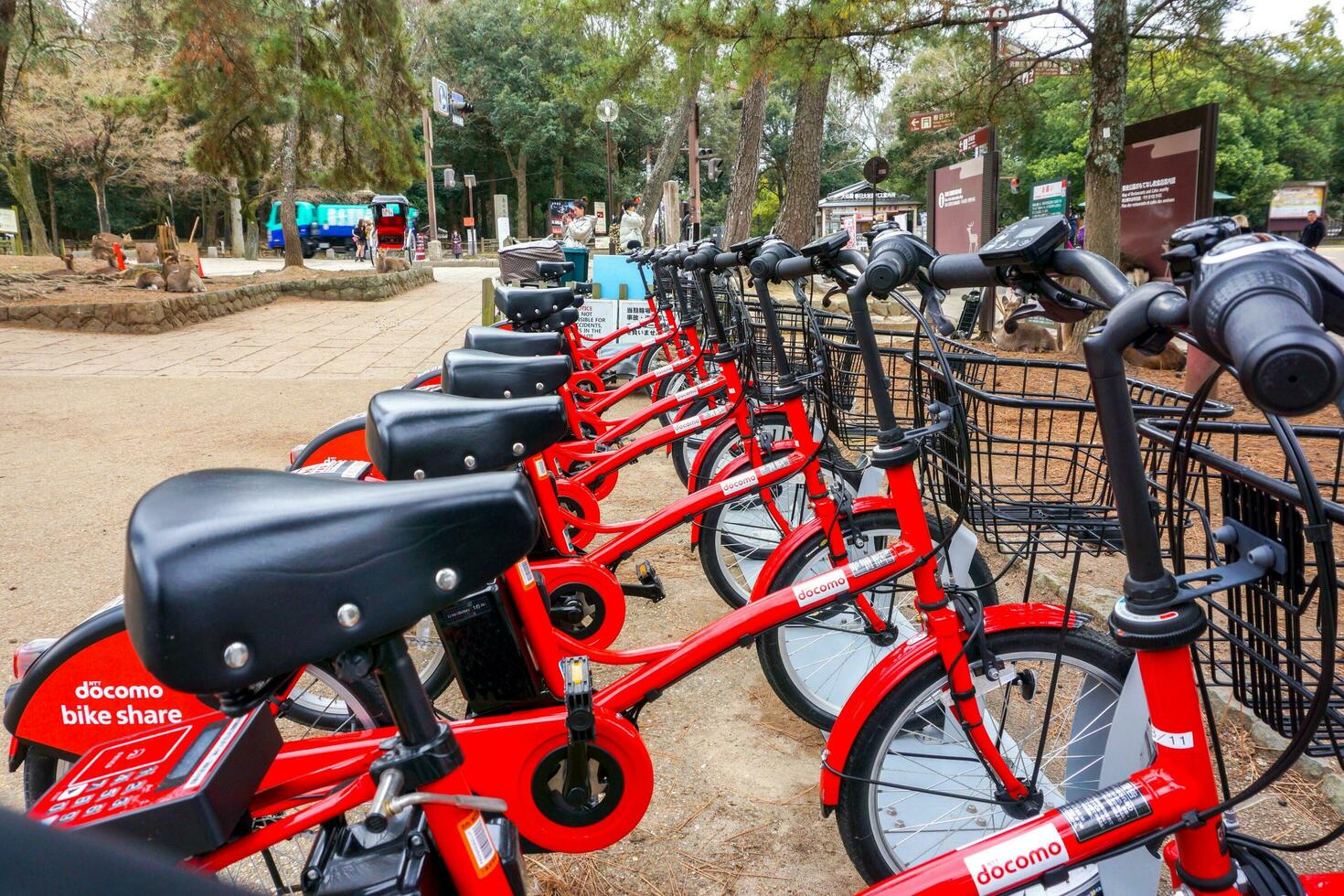 Nara City, Japan, 2019 - Japan public travel bikes of Docomo company parked for tourists interested in borrowing to ride at Nara park, Rent by register for the IC card at Docomo store. photo