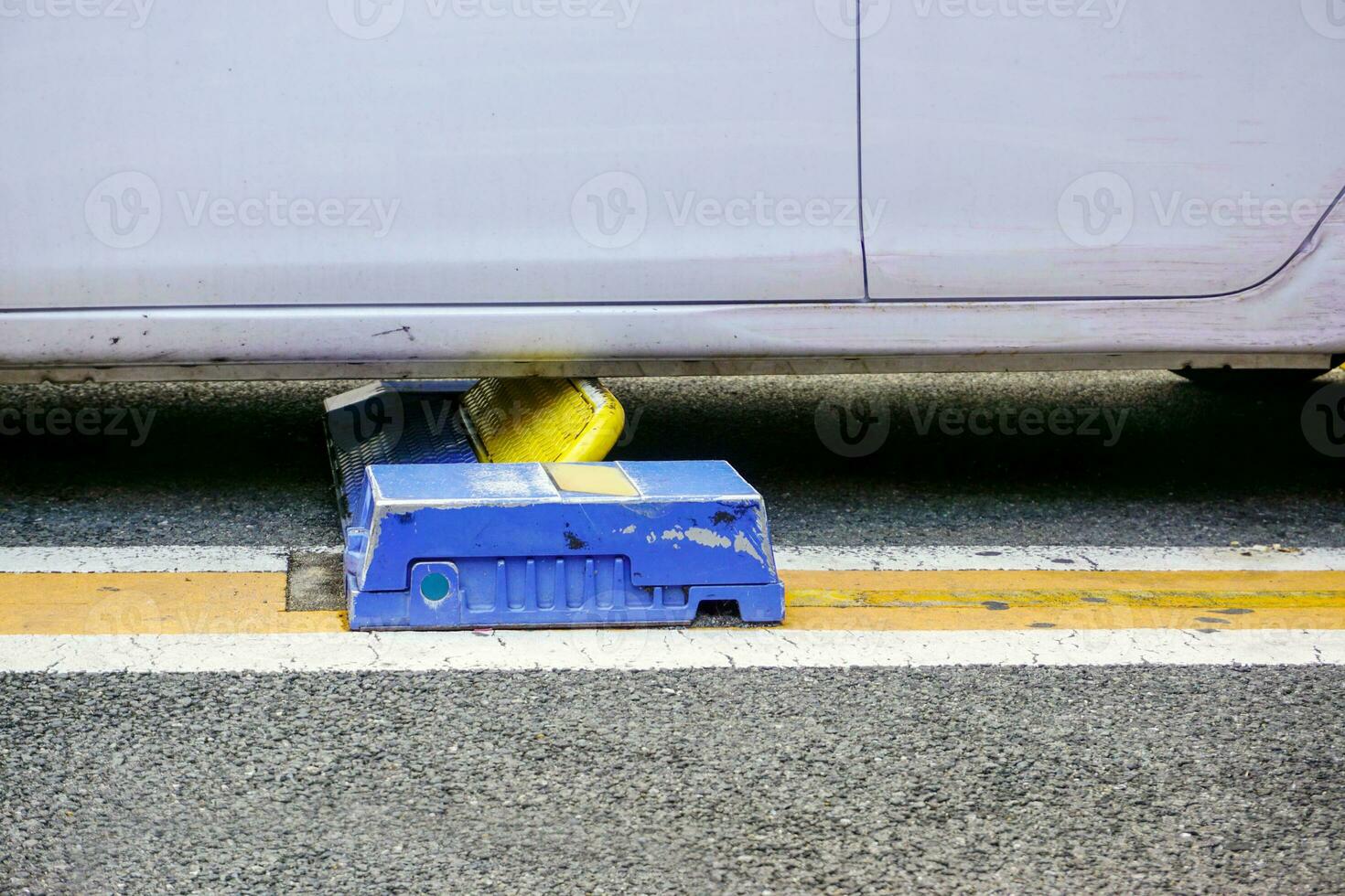 Closeup cars lock device work and locking a car in coins parking lot. photo