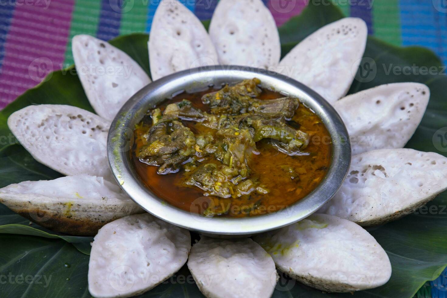 Bangladeshi Traditional Aush or Porangi Rice Special  Delicious tasty Chitoi Pitha Decorated on the green leaf with Duck Curry Recipe photo