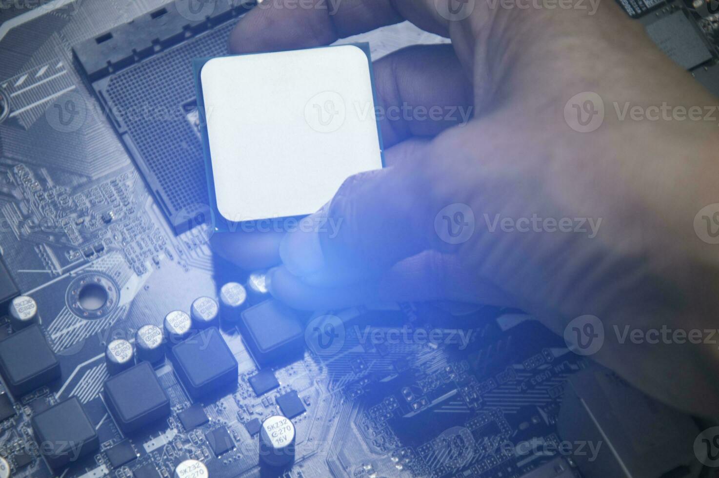 Top view of technician installing CPU chip on motherboard, CPU chip It's the brain part of the computer. photo