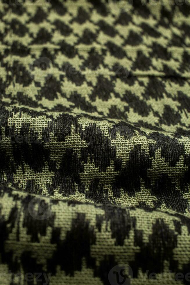 Keffieh scarf. The texture of the cotton traditional symbolic arabian scarf. Khaki back. photo