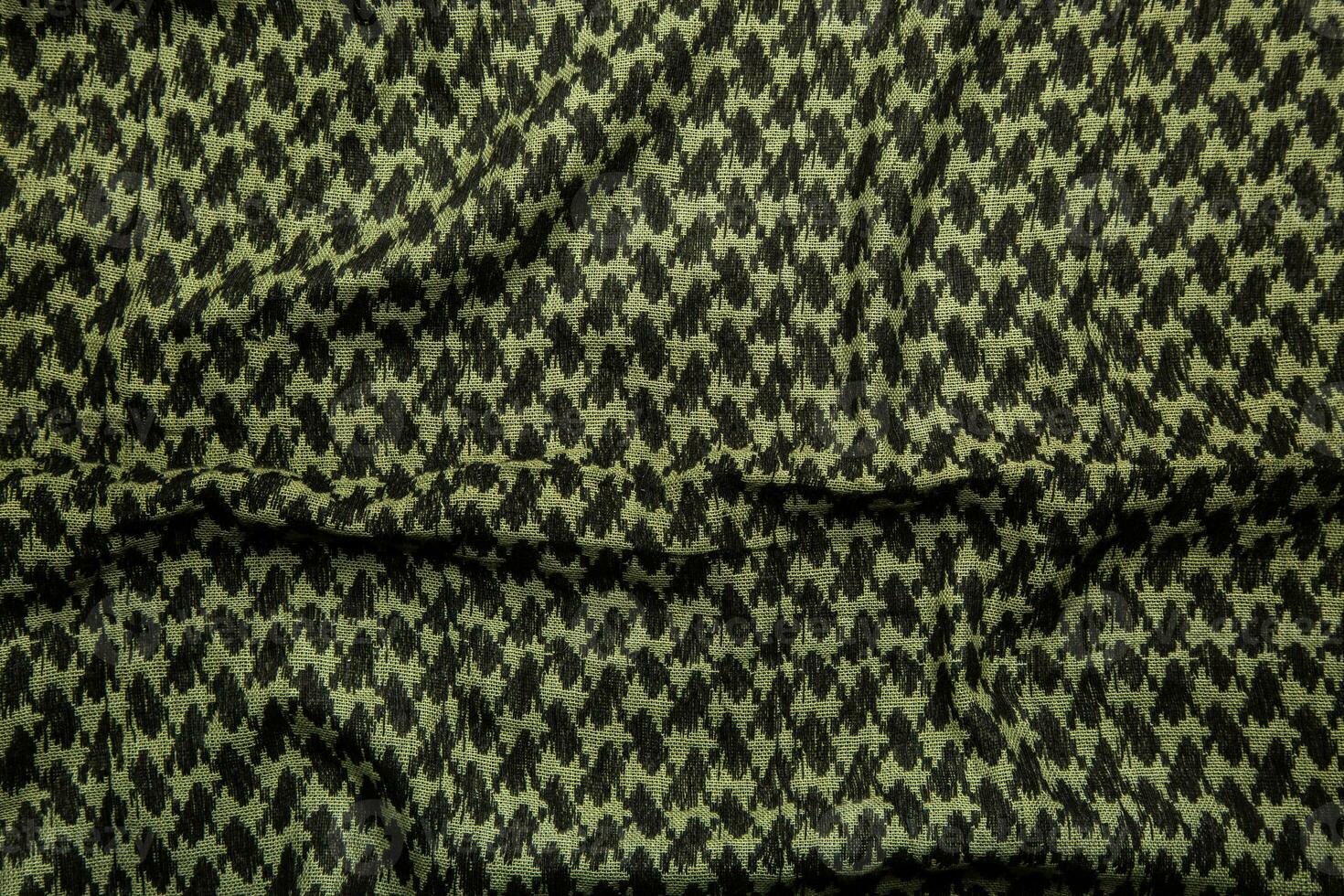 Keffieh scarf. The texture of the cotton traditional symbolic arabian scarf. Khaki back. photo