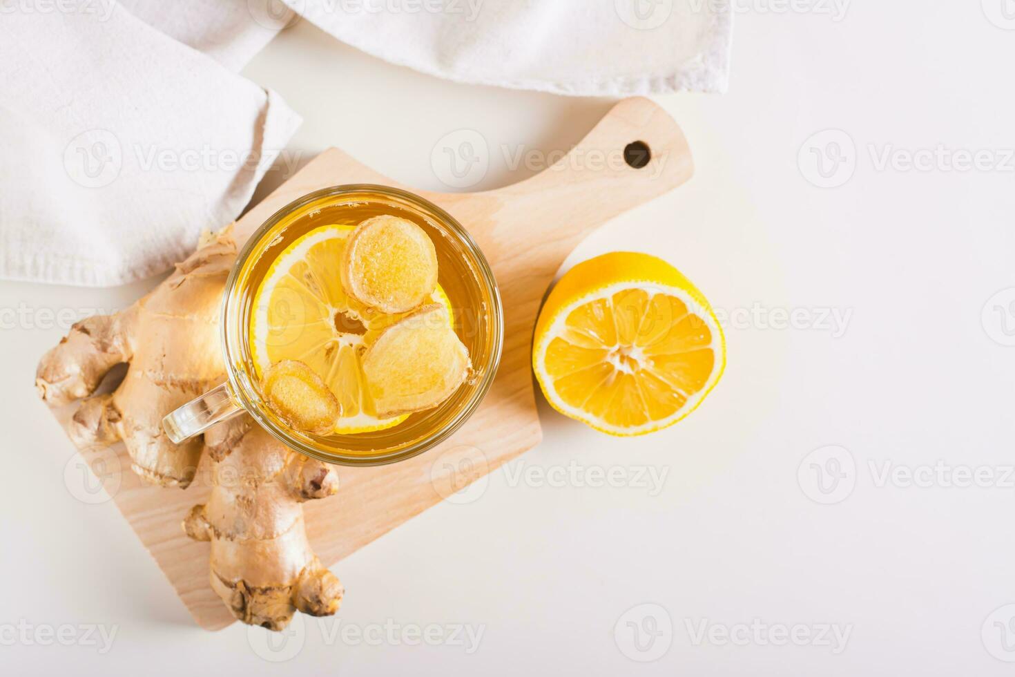 Homeopathic ginger lemon tea in a cup on the table top view photo