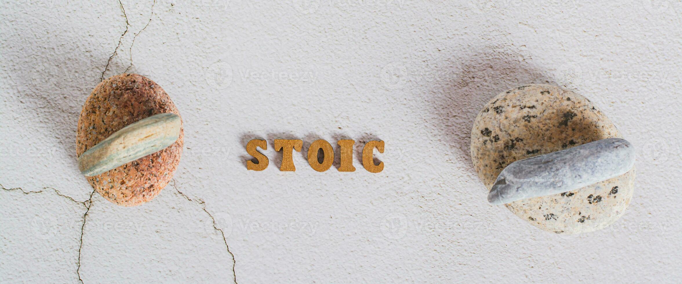 Concept stoicism word  from letters and stones on top of each other on gray top view web banner photo