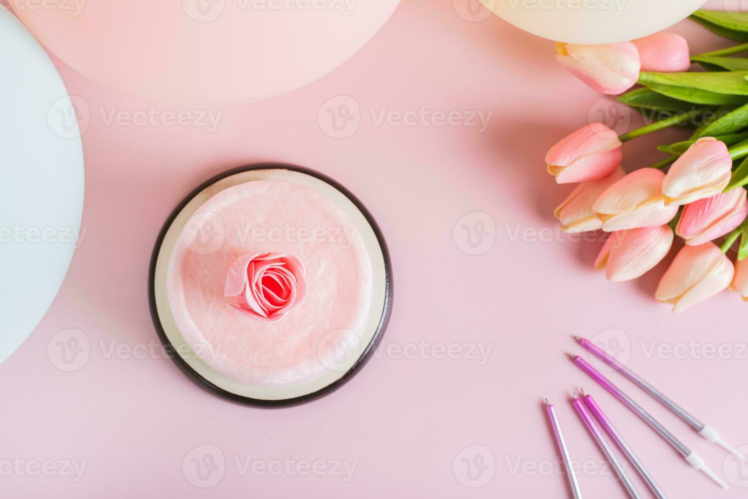 Colored cotton candy cake and party decorations on the table top view photo