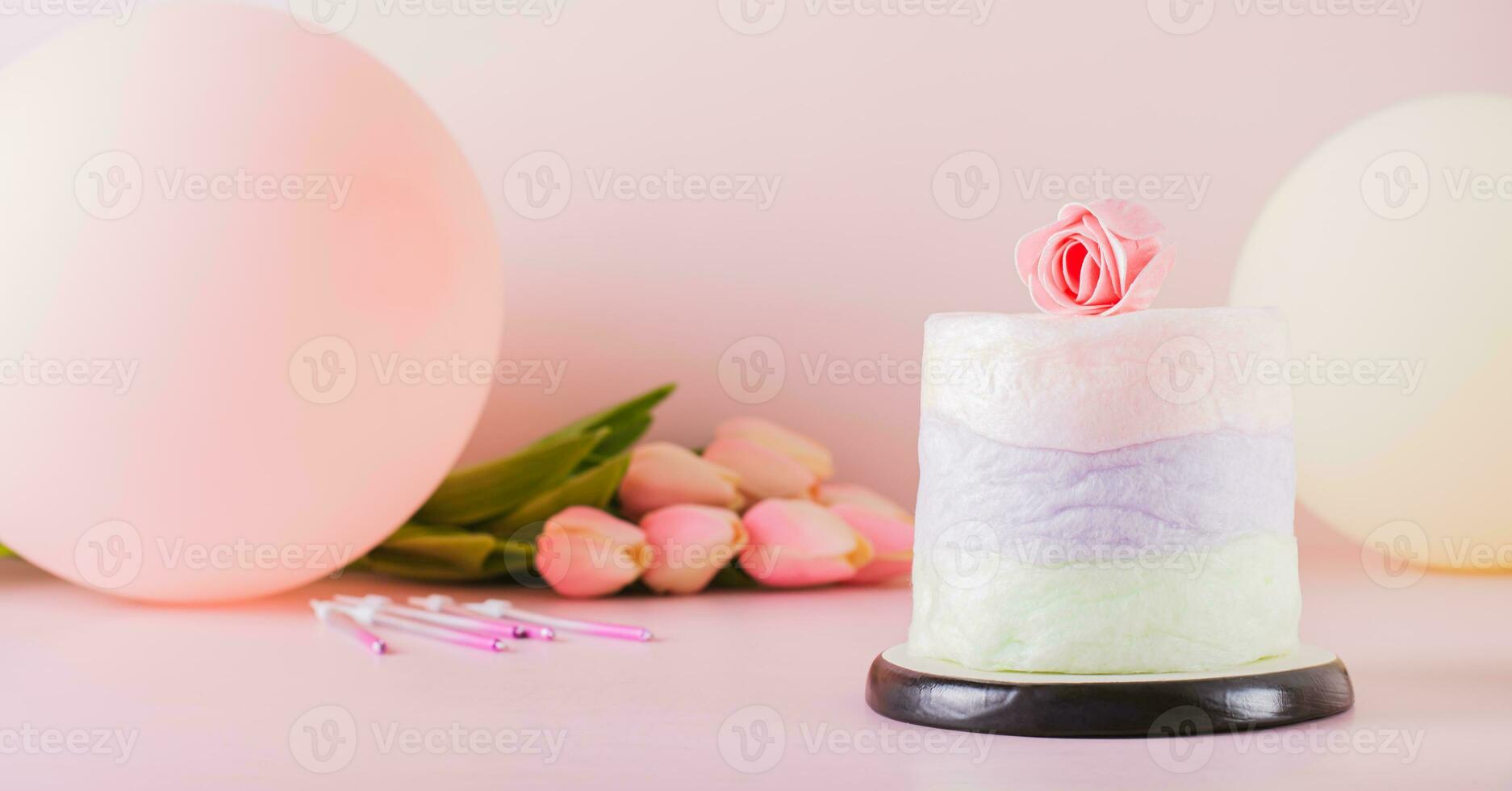 Colored cotton candy cake and party decorations on the table web banner photo