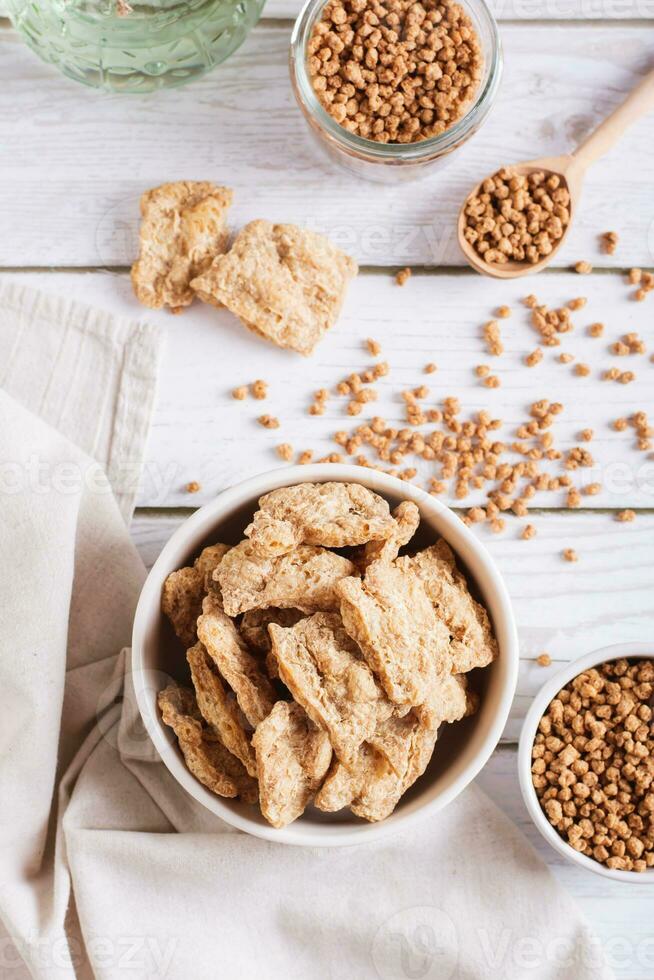Alternative protein dry soy meat in a bowl on the table top and vertical view photo