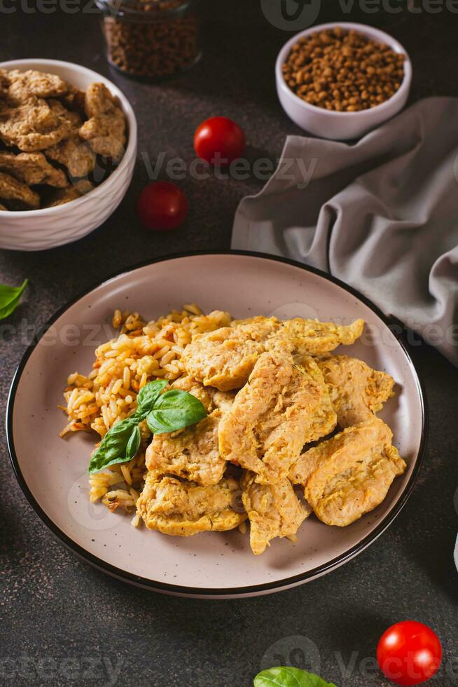 Alternative soy meat with rice on a plate on the table  vertical view photo