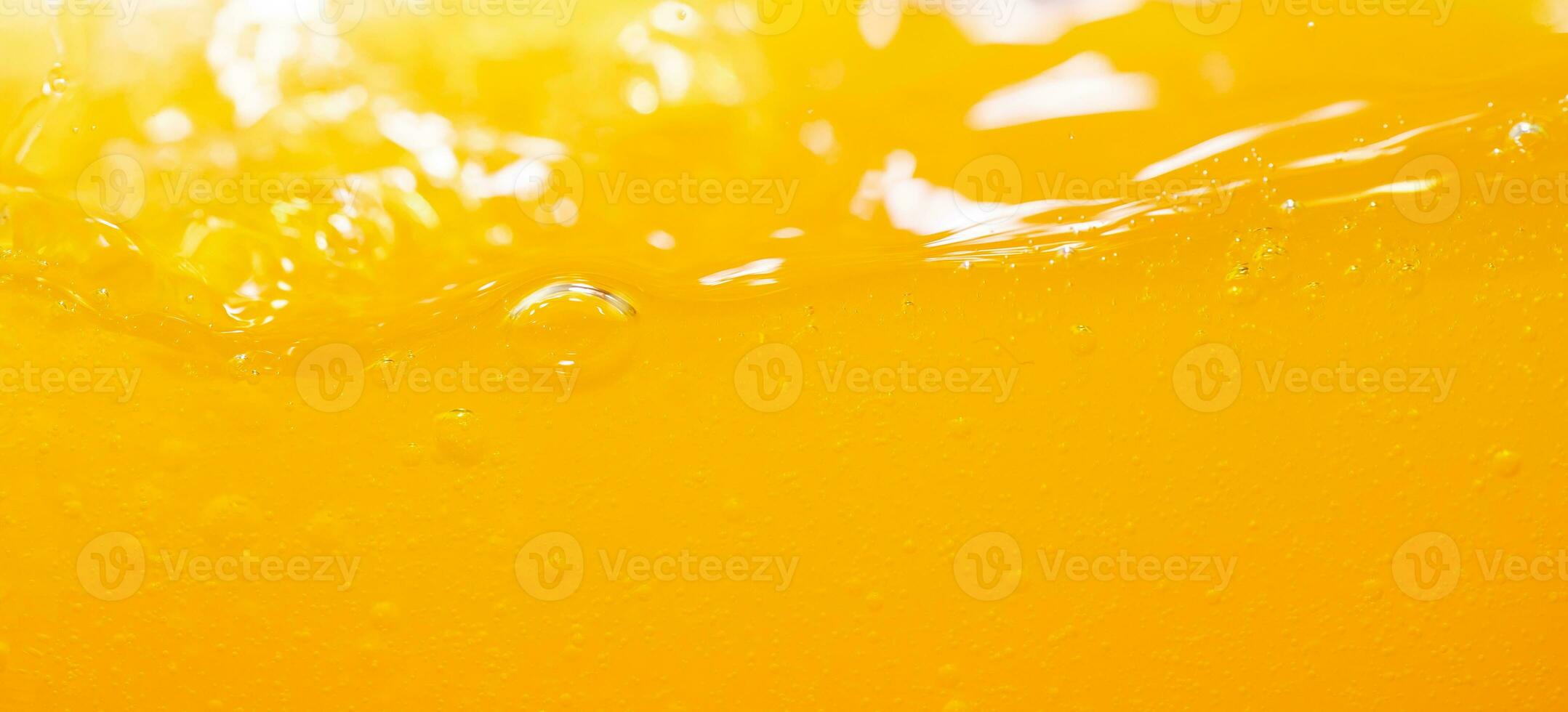 Close up bright orange juice splash texture for health and nature waves, Beautiful waves curve and little bubbles smooth for garphic design and background photo