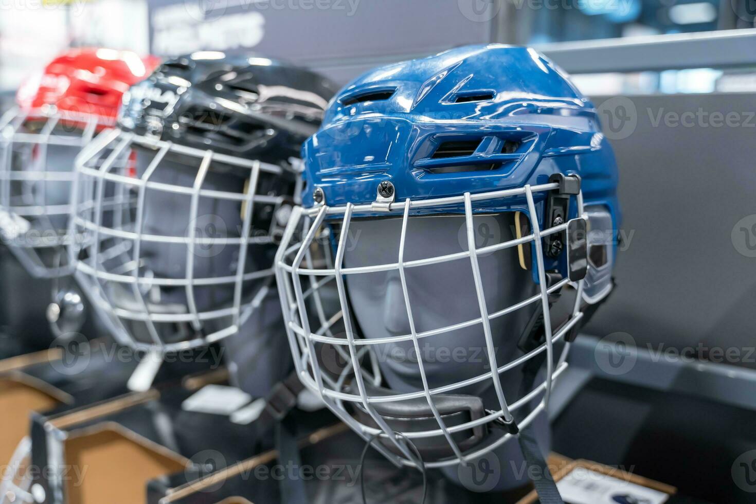 Assortment of Hockey Helmets in Blue and Red with Visors Store Display photo