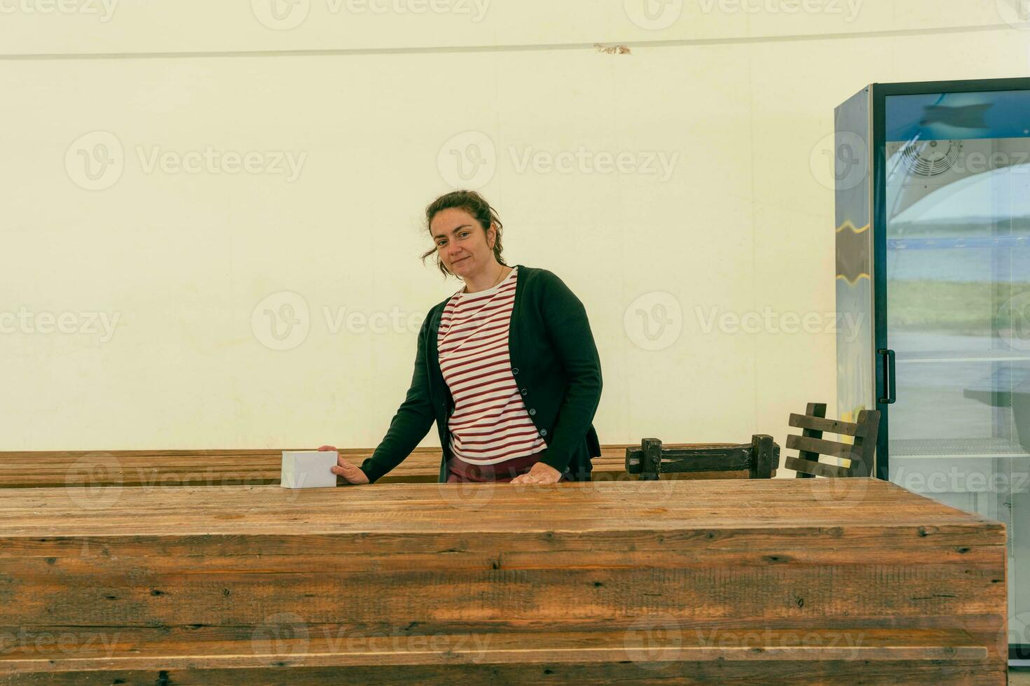 Empty Counter in Street Mass Event Tent, Female Organizer with Long