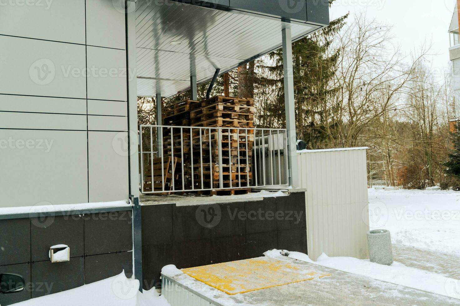 Wooden Pallets Stacked at Store's Unloading Point for Transport and Logistics photo