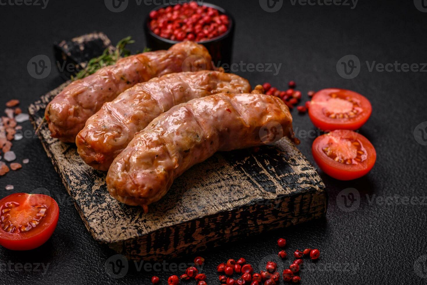 Delicious juicy grilled chicken or pork sausages with salt, spices and herbs photo