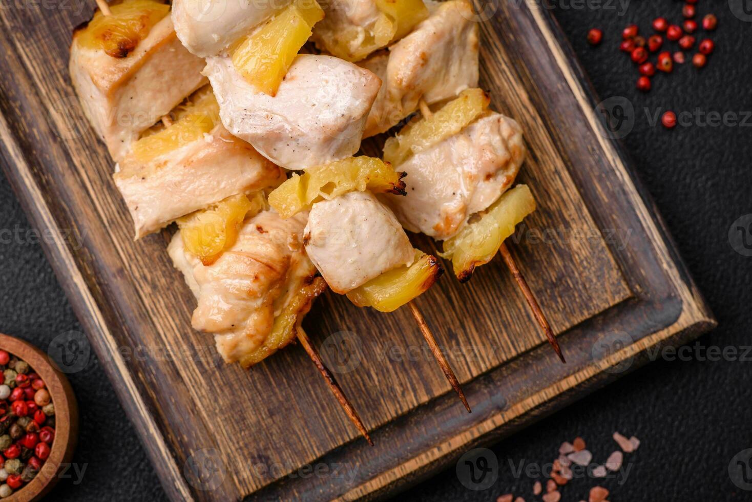 Delicious chicken or turkey kebab with pineapple pieces on skewers photo