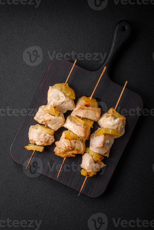 Delicious chicken or turkey kebab with pineapple pieces on skewers photo