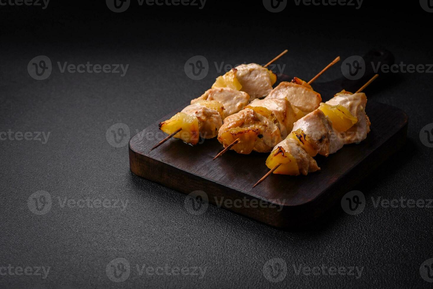 Delicious chicken or turkey kebab with pineapple pieces on skewers photo