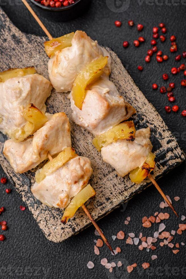 Delicious chicken or turkey kebab with pineapple pieces on skewers photo