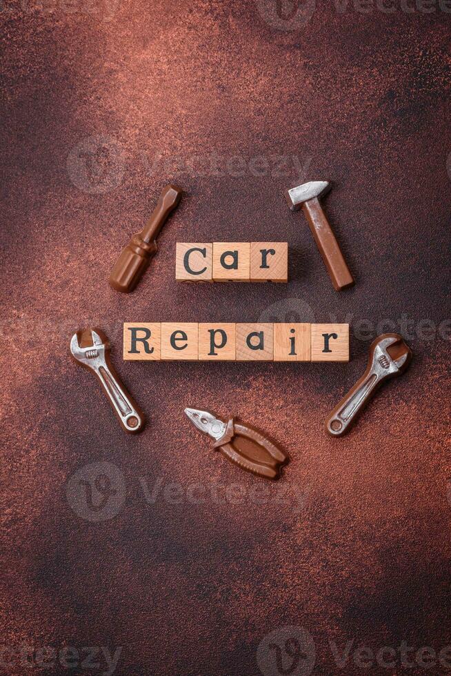 Tools and inscriptions symbolizing repairs or a garage and its attributes on a plain background photo