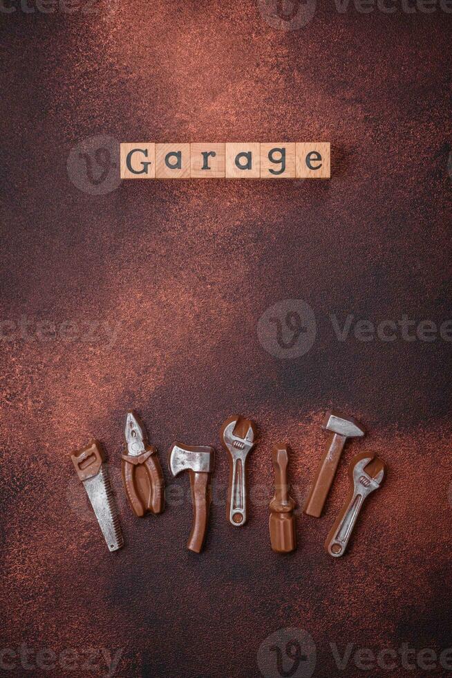 Tools and inscriptions symbolizing repairs or a garage and its attributes on a plain background photo