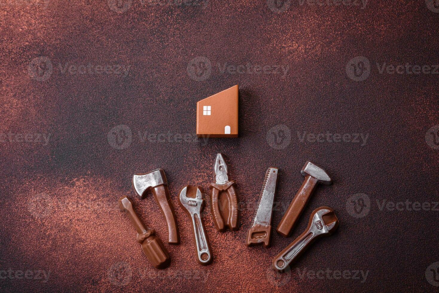 Repair or home improvement tools and a house model on a plain background photo