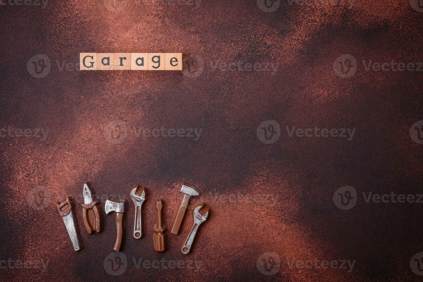 Tools and inscriptions symbolizing repairs or a garage and its attributes on a plain background photo