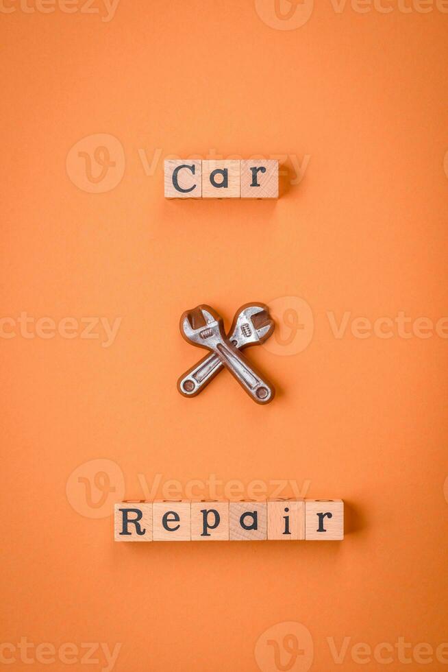 Tools and inscriptions symbolizing repairs or a garage and its attributes on a plain background photo