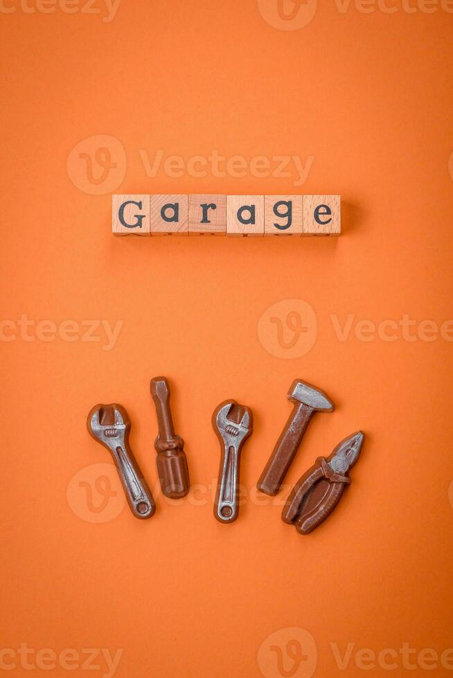 Tools and inscriptions symbolizing repairs or a garage and its attributes on a plain background photo