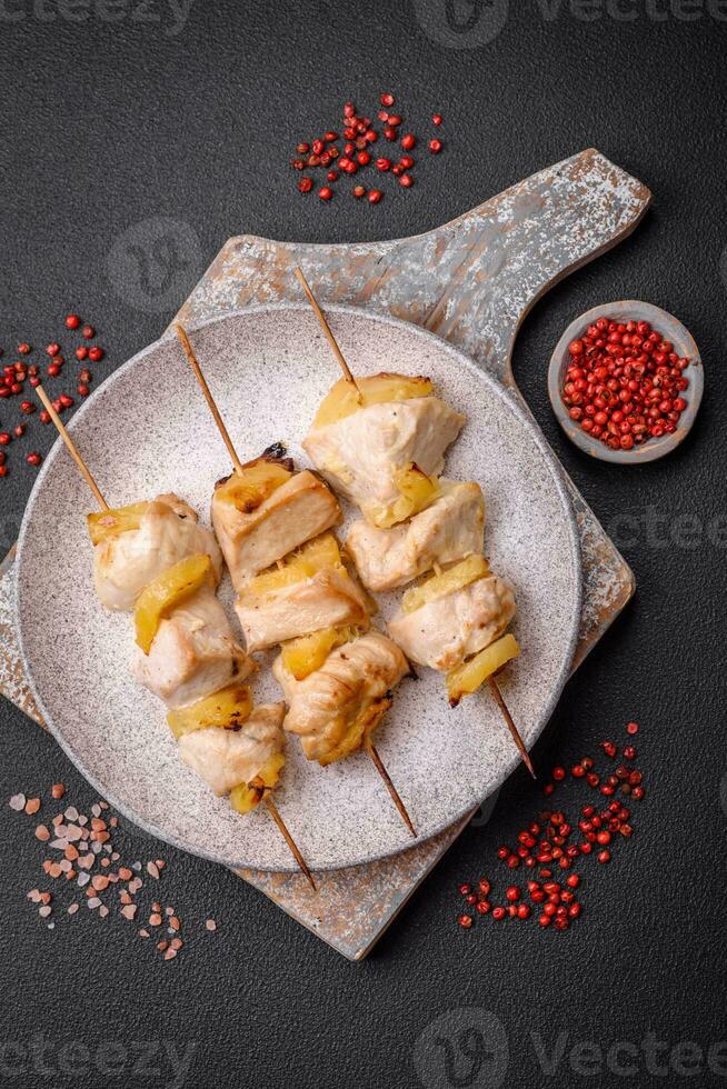 Delicious chicken or turkey kebab with pineapple pieces on skewers photo