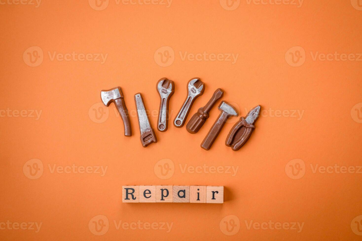 Tools and inscriptions symbolizing repairs or a garage and its attributes on a plain background photo