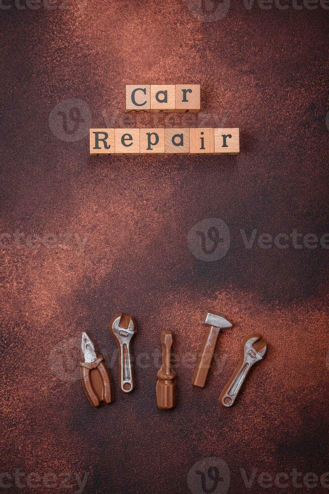Tools and inscriptions symbolizing repairs or a garage and its attributes on a plain background photo