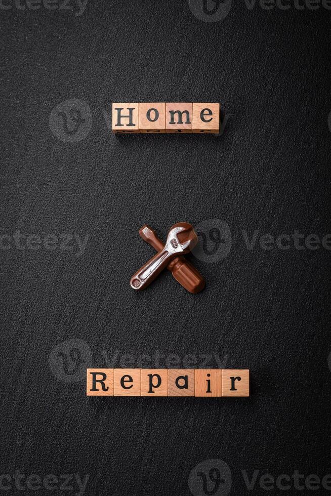 Tools and inscriptions symbolizing repairs or a garage and its attributes on a plain background photo