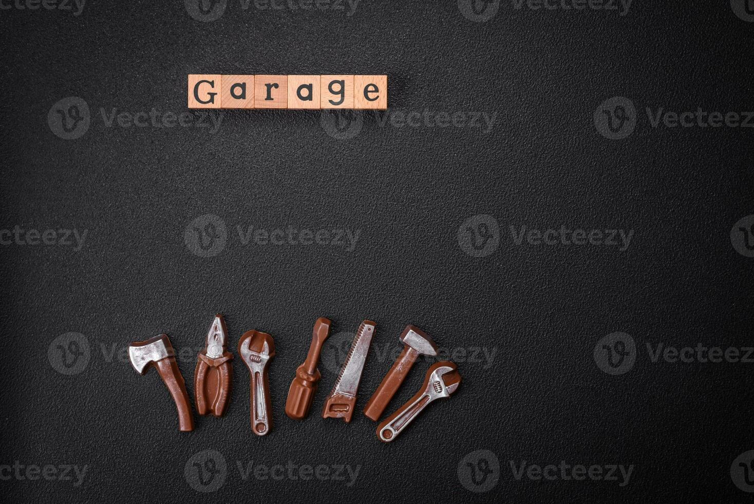 Tools and inscriptions symbolizing repairs or a garage and its attributes on a plain background photo